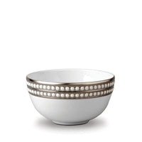 A white porcelain Perlée Platinum Dinnerware bowl by L'Objet features a platinum rim and two rows of raised white dots around the top edge, shown against a plain white background.