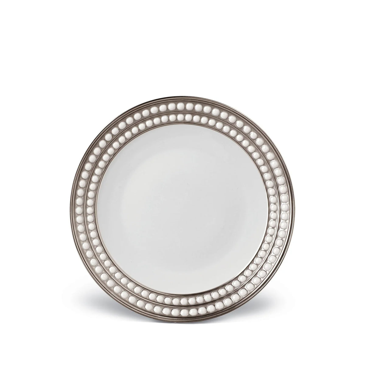 The L'Objet Perlée Platinum Dinnerware plate features a round white porcelain design with a platinum rim and two rows of raised, pearl-like beads for an elegant touch.