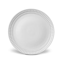 A beaded-rim charger plate from L'Objet's Perlèe White Dinnerware collection, shown on a white background.