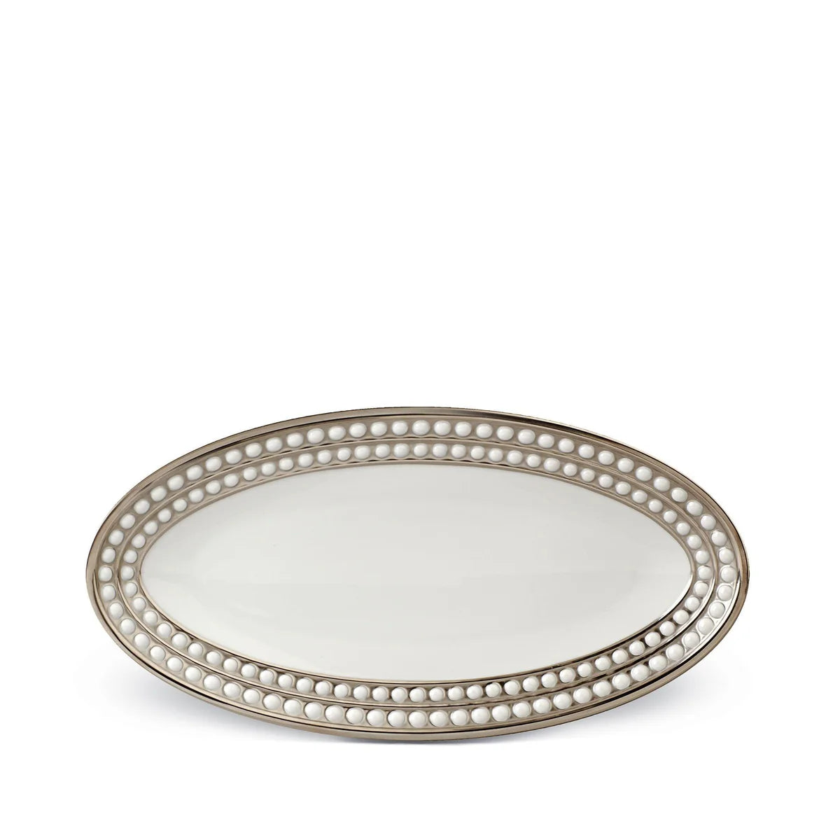The L'Objet Perlée Platinum Dinnerware features an oval-shaped white porcelain serving platter with raised beaded detailing and a shimmering platinum rim.
