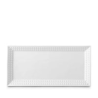 The Perlée White Dinnerware by L'Objet features a rectangular white Limoges porcelain platter with a beaded border—ideal as a charger plate for elegant table settings, shown on a plain white background.