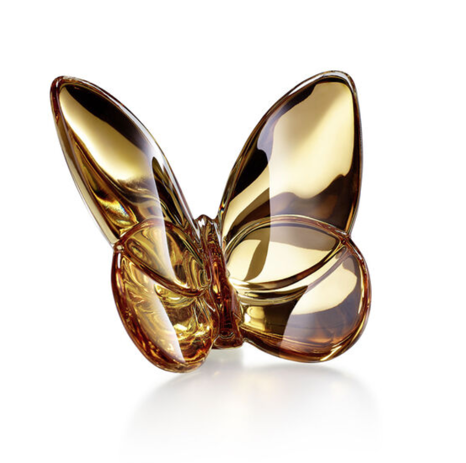 The Papilion Lucky Butterfly by Baccarat is a golden glass crystal figurine with smooth, reflective wings, displayed on a white background—an elegant lucky-charm gift for any occasion.