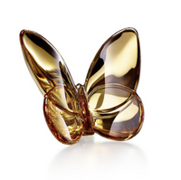 The Papilion Lucky Butterfly by Baccarat is a golden glass crystal figurine with smooth, reflective wings, displayed on a white background—an elegant lucky-charm gift for any occasion.