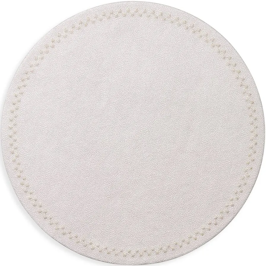 The Starry Night Placemat s/4 by Kim Seybert features a round, light beige textured design with subtle stitching and metallic trim—an easy-to-clean placemat that brings elegance to any table setting.