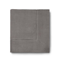 The Sferra Festival Tablecloth is a neatly folded gray fabric with a decorative hemstitch border, shown against a white background.