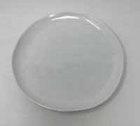 The Relish Simple White Melamine Dinnerware, a best seller, features a plain, round plate with a smooth, glossy finish. Set against a white background, it appears clean and is dishwasher safe for easy care.