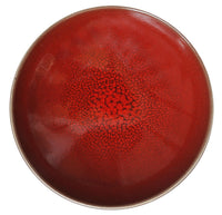 The Tourron Dinnerware Cerise by Jars - Rosenthal is a round ceramic plate with red crackled glaze, a subtle gradient to a matte brownish rim, and is dishwasher safe for easy care.