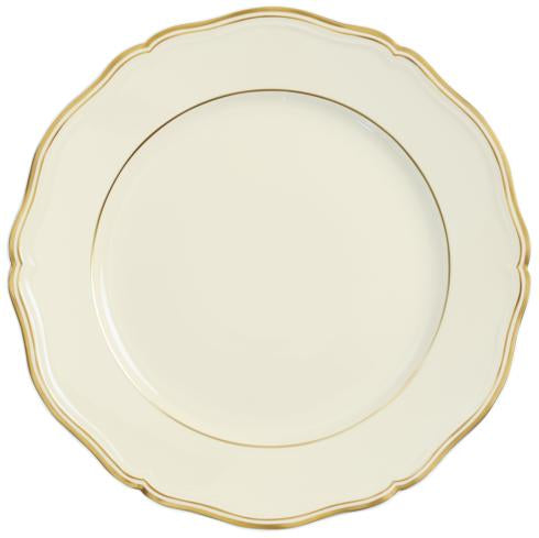 A Mazurka Gold & Ivory dinnerware plate by Raynaud features a cream color, scalloped edge, and thin gold trim, exemplifying French craftsmanship, set against a white background.