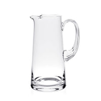 The Fanny Pitcher by William Yeoward features a clear glass body, wide base, narrow top, curved handle, and small spout—a stylish decorative jug or thoughtful wedding gift.