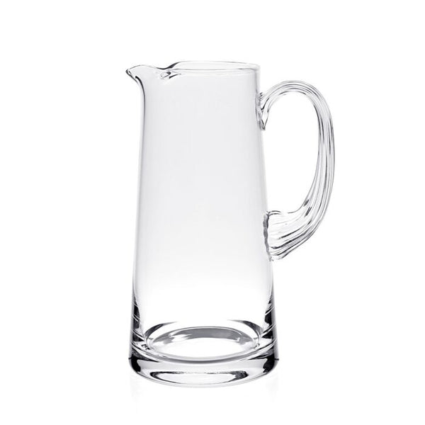 The Fanny Pitcher by William Yeoward features a clear glass body, wide base, narrow top, curved handle, and small spout—a stylish decorative jug or thoughtful wedding gift.