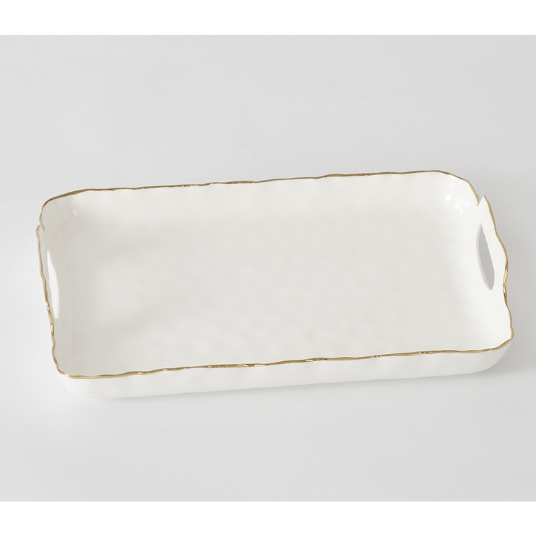 The PAMPA BAY Portofino Handle Rectangle Tray is a white porcelain serving tray with wavy edges, handles, a gold-rimmed border, and a subtle textured surface for an elegant and functional presentation.