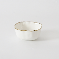 The PAMPA BAY Portofino Snack Bowl Gold features a scalloped rim and thin gold trim—perfect for serving treats oven to table. Set against a plain white background.