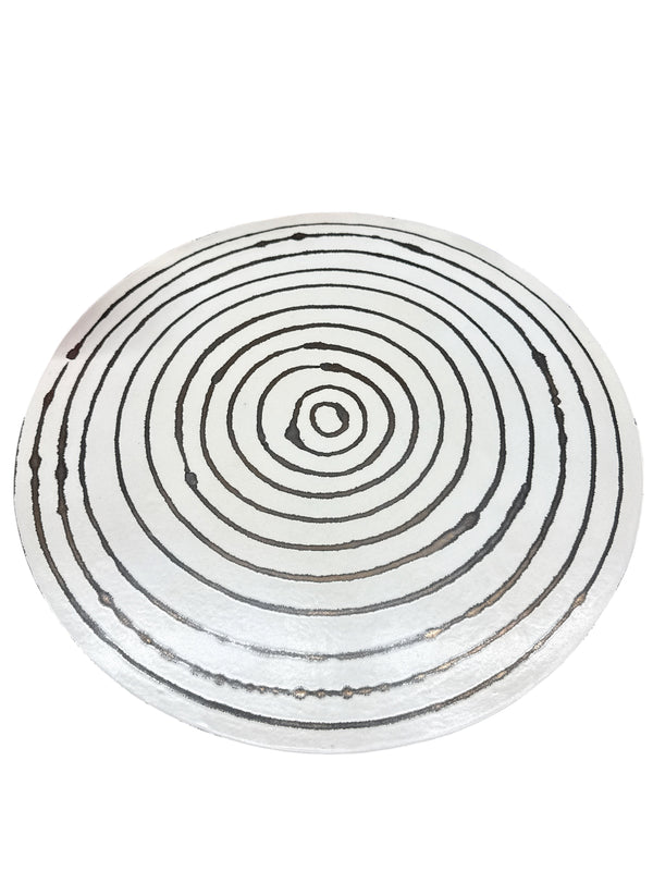 The Michael Wainwright Linea Lazy Susan - Medium features evenly spaced black concentric circles on a white background, hand painted in a design reminiscent of stylized tree rings or a target. This piece from the Linea collection brings modern elegance to any space.