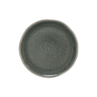 A round, dark gray Maguelone Orage stoneware plate by Jars - Rosenthal with a slightly irregular rim, viewed from above on a white background.