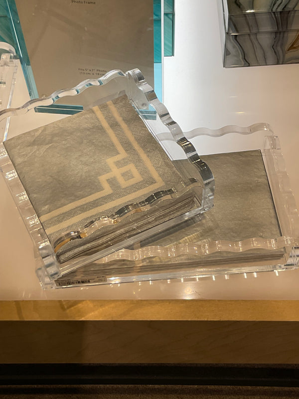 Tizo Waverly Guest Towel Holder in clear, scalloped-edge acrylic, containing a stack of grey and white patterned paper guest towels.