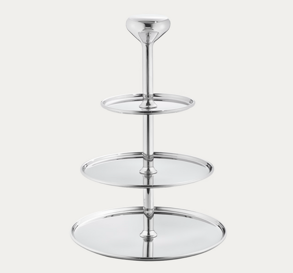 The Alfredo Ètagère by Georg Jensen is a polished silver, three-tiered serving tray with a central vertical stand and round trays that increase in size from top to bottom, presented against a plain white background.