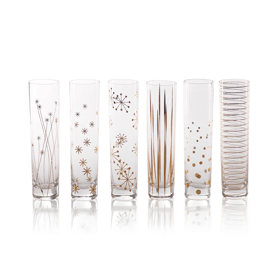 A set of six tall, slender stemless Celestial Champagne Flute Set of 6 - Gold flutes, each decorated with a unique gold-colored geometric or starburst pattern.