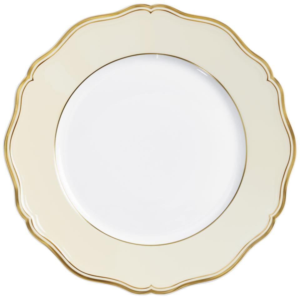 The Raynaud Mazurka Gold & Ivory plate features a scalloped edge, cream-colored border with gold trim, and a plain white center—a stunning example of French porcelain craftsmanship.