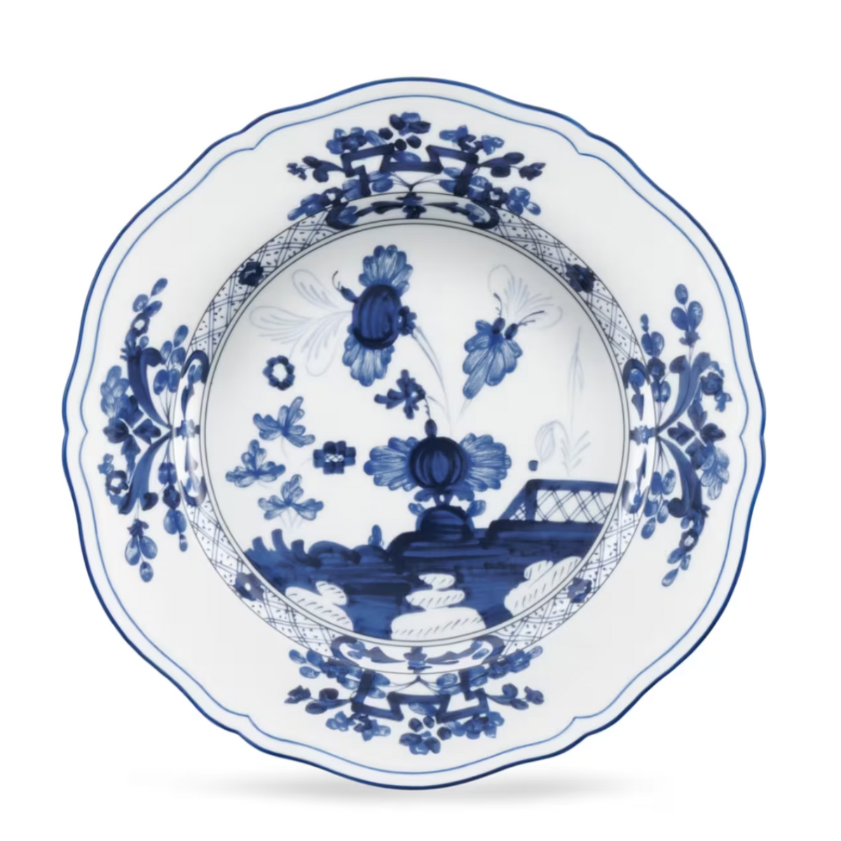 Ginori 1735 Oriente Italiano Indaco scalloped Antico Doccia porcelain soup plate featuring blue floral and landscape patterns on a white background.