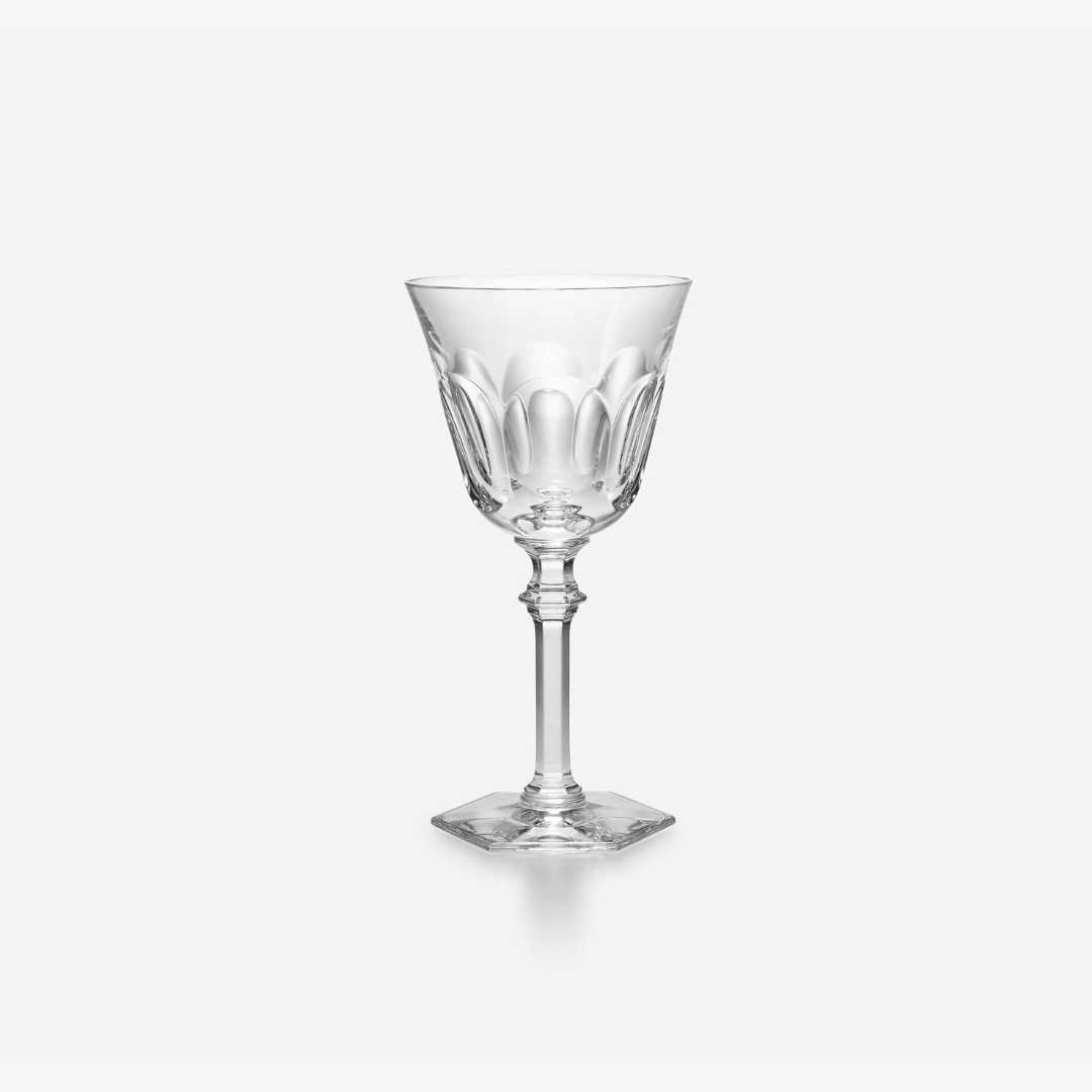 The Baccarat Eve Wine Glass, featuring a clear faceted bowl, slender stem, and square base, is shown against a plain white background.