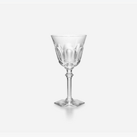 The Baccarat Eve Wine Glass, featuring a clear faceted bowl, slender stem, and square base, is shown against a plain white background.