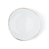 The Simply Gold Dinnerware plate by Molecot is a white, oval Limoges porcelain piece featuring a thin gold rim, displayed on a white background.