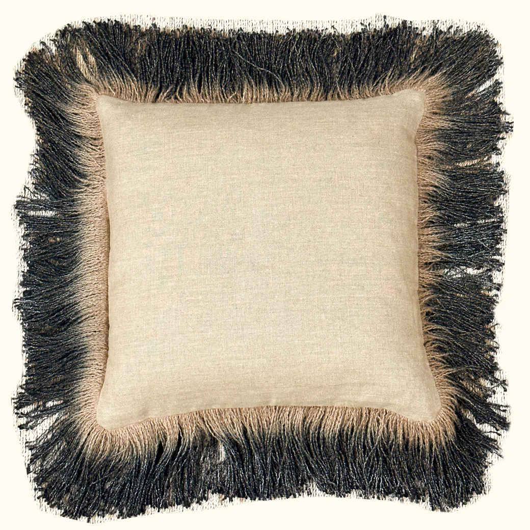 The Threads Soft Goods Jute Hand Dyed Fringe Pillow Carbon is a square beige pillow with textured linen fabric and thick black and beige fringe trim, shown against a plain background.