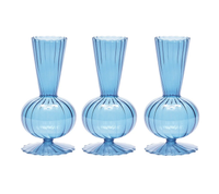 The Kim Seybert Tess Bud Vase Set of 3 in blue features identical hand-blown glass vases with ribbed, spherical bases and flared, textured rims, arranged in a row against a white background.