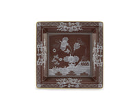 The Oriente Italiano Castagna square brown porcelain plate by Ginori 1735 features a white floral and geometric border, gold trim, and stylized central flowers with a fence motif. Made in Italy.