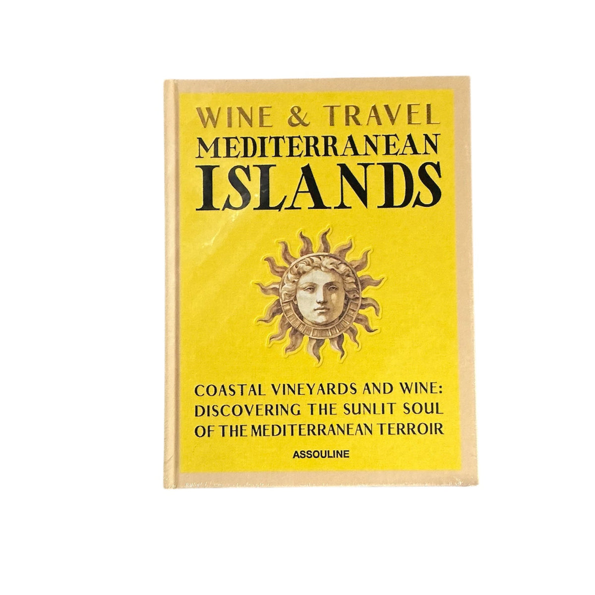 Assouline’s Wine & Travel Mediterranean Islands is a yellow book with a sun face illustration, exploring coastal vineyards and the essence of Mediterranean Islands wine.