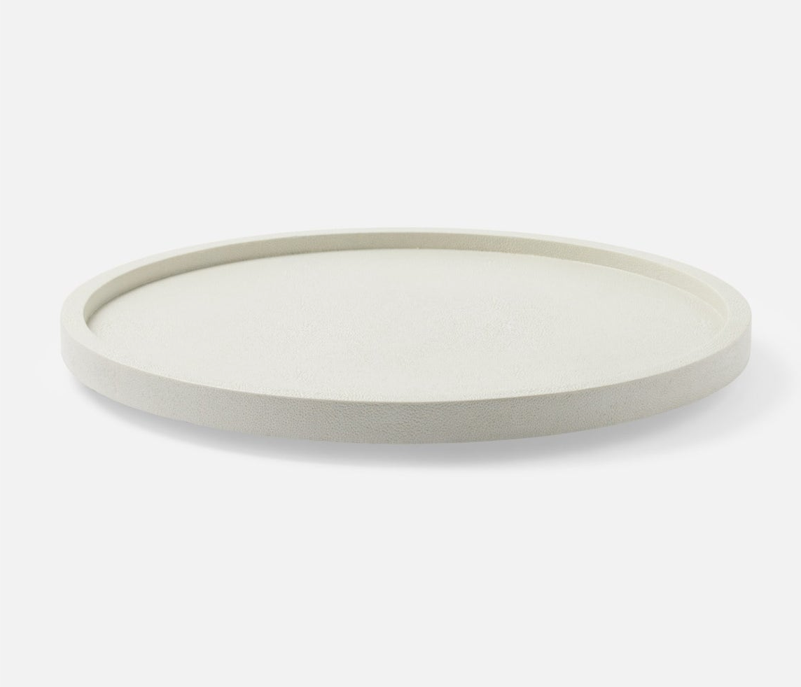The Blue Pheasant Calvin Faux Shagreen Lazy Susan White is a simple, round, off-white tray with a slightly raised rim, shown against a plain white background.