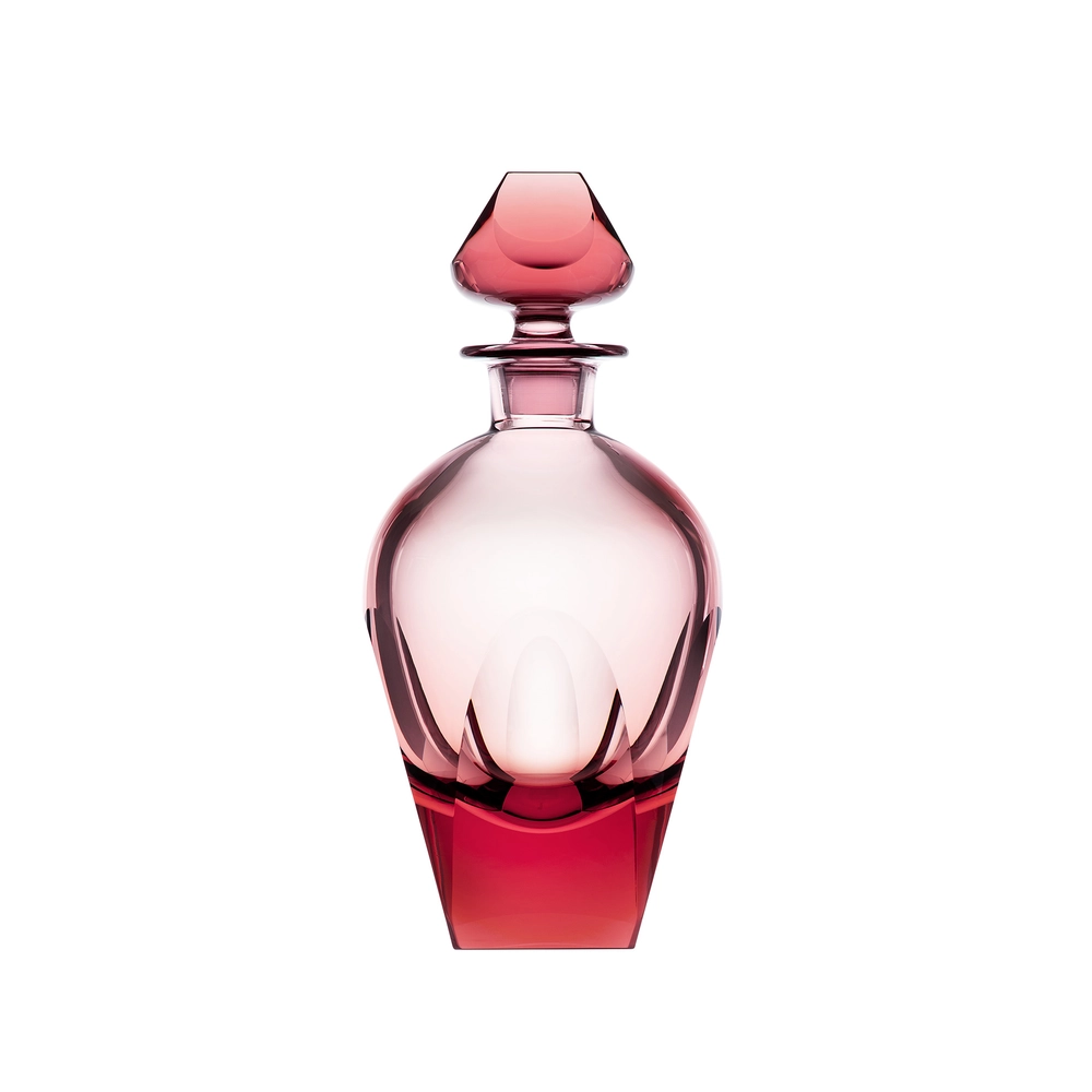 The Moser Bar Decanter 750 ml is an elegant pink-tinted glass bottle with smooth curves, faceted edges, and a matching geometric stopper, reminiscent of luxury barware, displayed against a white background.