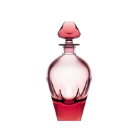 The Moser Bar Decanter 750 ml is an elegant pink-tinted glass bottle with smooth curves, faceted edges, and a matching geometric stopper, reminiscent of luxury barware, displayed against a white background.