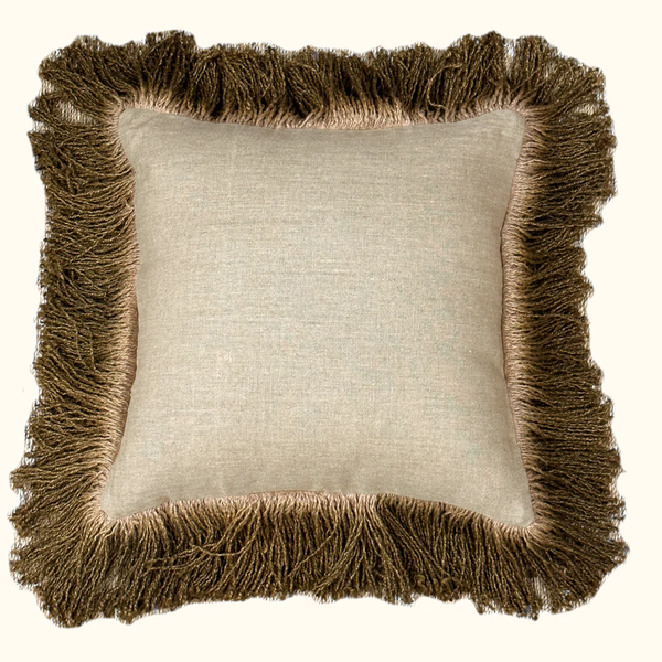 The Jute Hand Dyed Fringe Pillow Bronze by Threads Soft Goods is a beige square pillow made from natural linen with thick, hand-dyed bronze jute-like fringe around the edges, displayed on an off-white background.