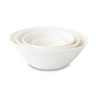 A set of four white, hand-sculpted ceramic nesting bowls by Tina Frey, named Sculpt Tapered Bowl White, displayed on a white background.