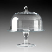 The William Yeoward Classic Cake Dome 11″ is an elegant cake display, featuring a clear round base and a matching antique-inspired dome cover, both expertly crafted from handmade crystal glass and shown against a gray to black gradient background.
