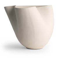The Carmen Vase by FlowDecor Inc. features an abstract white ceramic design with an asymmetrical, flowing form and a smooth matte finish, displayed against a plain white background.