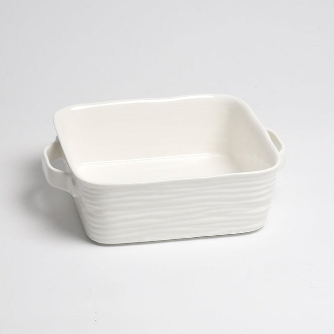 The PAMPA BAY Le Blanc Square Baker is a rectangular white porcelain dish with two side handles. Oven safe and dishwasher safe, it is shown on a plain white background.