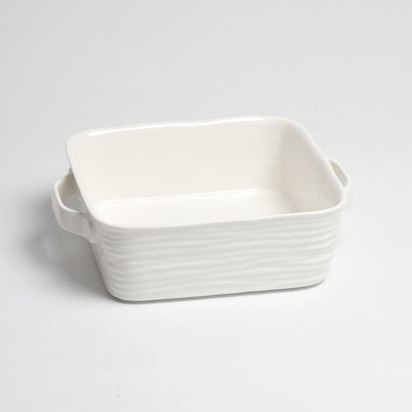 The PAMPA BAY Le Blanc Square Baker is a rectangular white porcelain dish with two side handles. Oven safe and dishwasher safe, it is shown on a plain white background.
