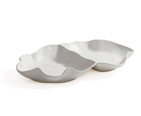 The Zodax Alto Two Section Ceramic Serving Bowl features a modern, sculptural matte white design with two connected, irregular compartments, resembling abstract leaf or shell forms.