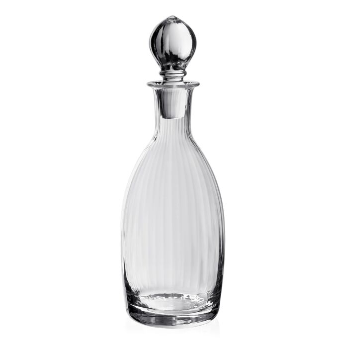 The Corinne Decanter and Stopper by William Yeoward features a Jazz Age-inspired design with vertical ridges, a round base, long neck, and matching stopper—a sophisticated glassware piece for any setting.