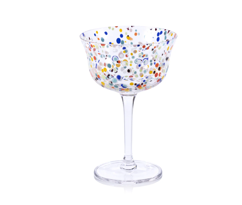 The Spritz Sprinkles Cocktail Glass by Zodax features a clear wide bowl and thin stem, decorated with vibrant blue, yellow, orange, red, and green polka dots—perfect for adding charm to any festive table.