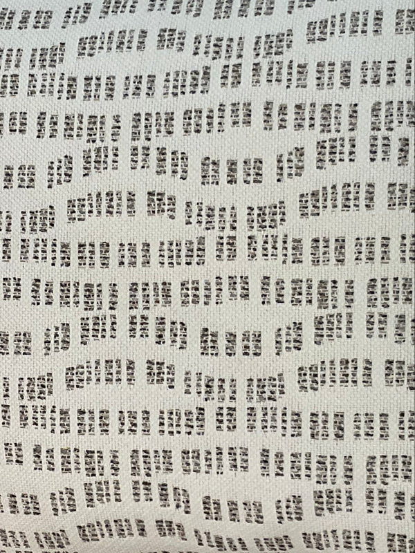 Close-up of the Pebble Path Linen Pillow by Decor Fifty-Five, shown against a white background. Its pattern of small, irregular black rectangular dashes in rows offers a perfect neutral touch for subtle style.