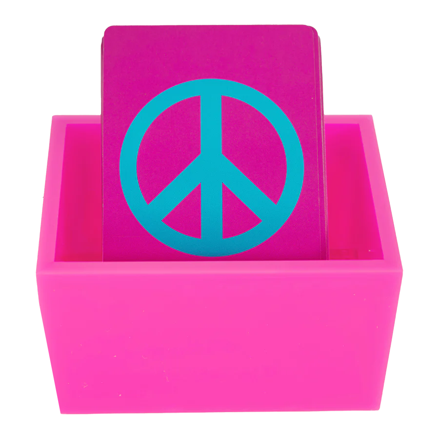 The Canasta Sets Canasta 2 Deck Holder features a magenta card with a bold blue peace symbol, standing upright in a matching box—an eye-catching holder, perfect for Canasta sets or your favorite card games, set against a crisp white background.