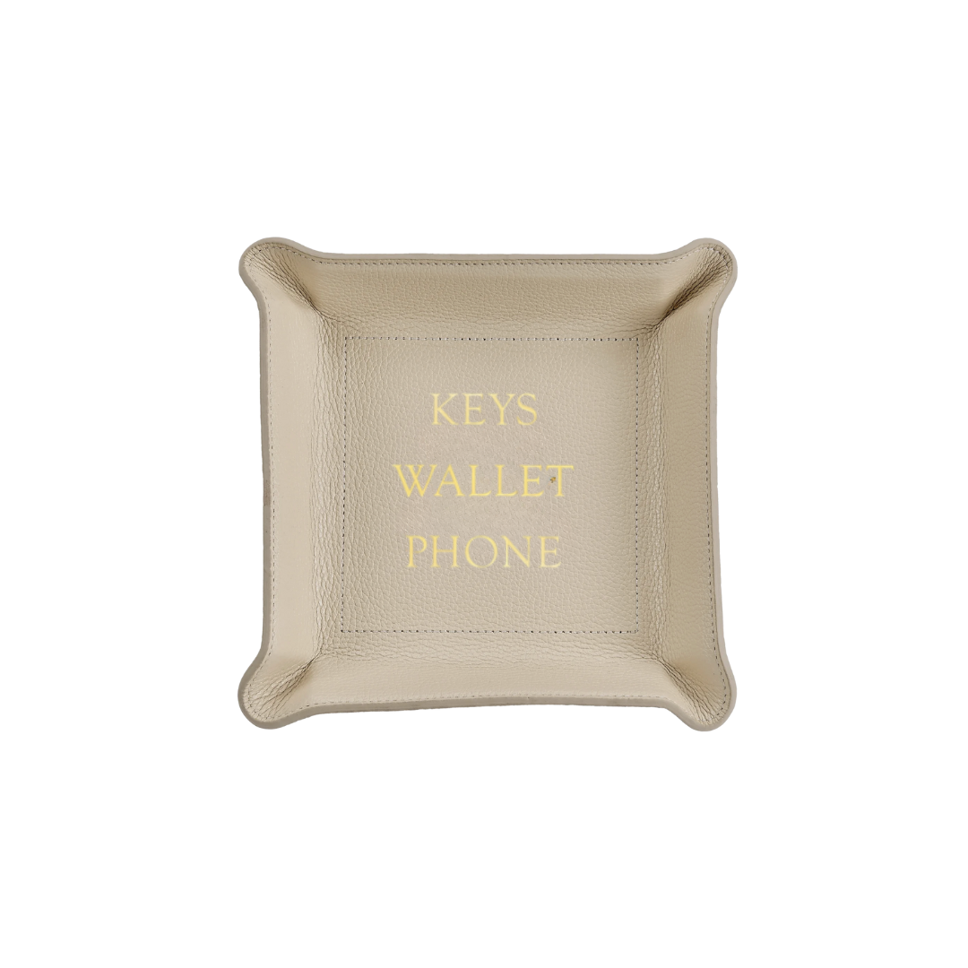 The Leather Valet Tray - Keys Wallet Phone by Graphic Image is a light beige leather catchall with KEYS, WALLET, and PHONE embossed in gold, providing a stylish way to organize your essentials.