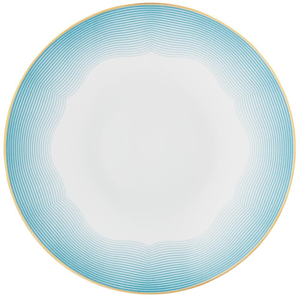 The Aura Dinnerware by Raynaud is a round white plate with a light blue wavy rim, thin gold edge, and plain center. Featuring contemporary design elements, it is crafted in France.