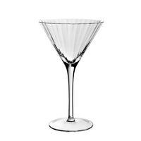 The Corinne Drinkware by William Yeoward features a clear, empty martini glass with a long stem and wide conical bowl, showcasing contemporary barware style against a plain white background.