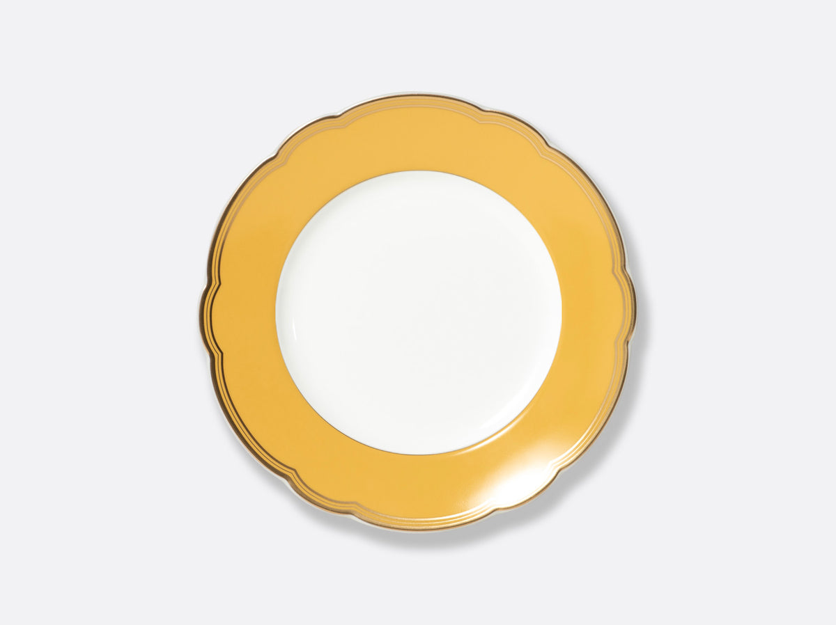 The Bernardaud Pompadour dinner plate features a round white center, wide scalloped yellow border, and thin gold rim, elegantly photographed on a light gray background—fine Limoges porcelain.