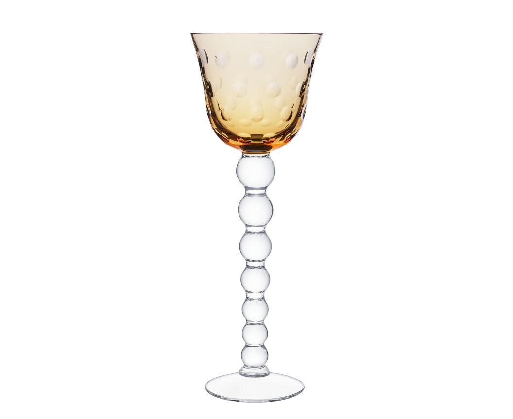 The Bubbles Hock Stemware by Saint-Louis features an amber dimpled bowl, a clear stem of stacked glass spheres, and a flat base—a striking design inspired by contemporary Saint-Louis crystal tableware.