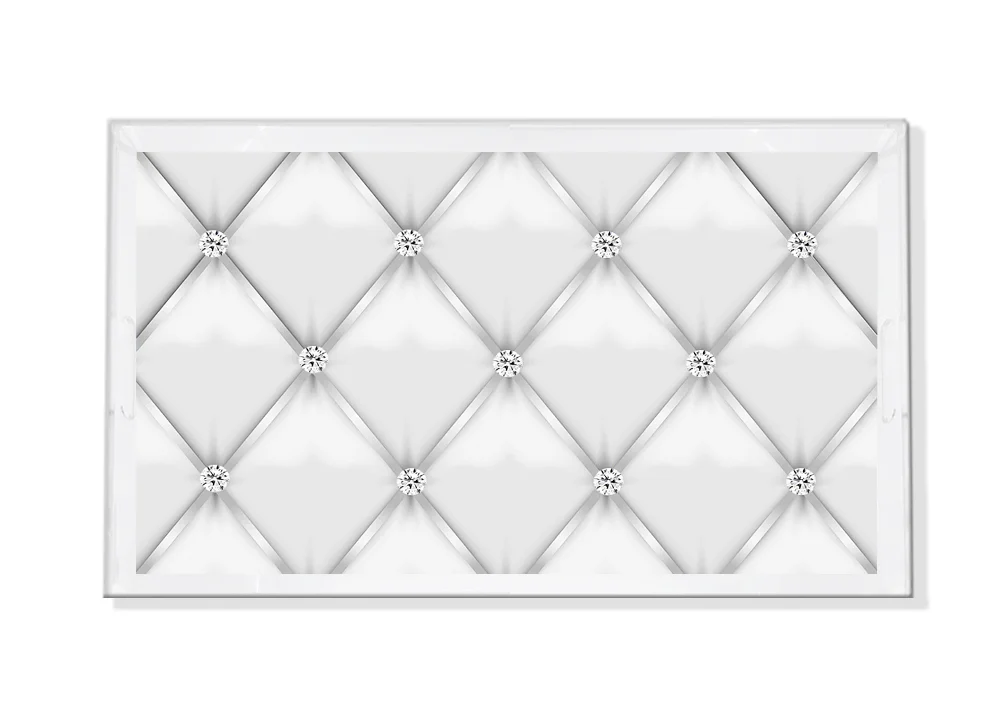 The Nicolette Mayer Tufted Silver with Diamonds Vanity Tray features a glossy white quilted design with silver studs, raised edges, and is ideal for displaying jewelry or organizing your vanity in elegant style.
